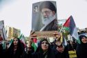 A demonstrator holds up a portrait of Iran's supreme leader Ayatollah Ali Khamenei at a Tehran rally called to celebrate the Revolutionary Guards' weekend missile and drone attack against Israel