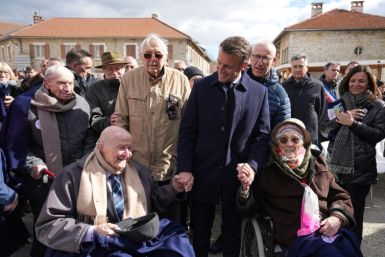 French President Emmanuel Macron meets 98-year-old former Resistance fighter Alphonse Taravello (left) and 99-year-old Yvonne Cheval (right), who lost part of her family during World War II