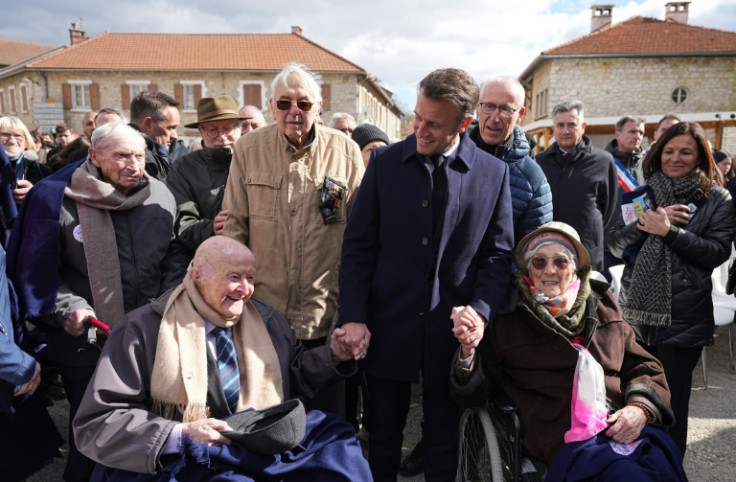 French President Emmanuel Macron meets 98-year-old former Resistance fighter Alphonse Taravello (left) and 99-year-old Yvonne Cheval (right), who lost part of her family during World War II