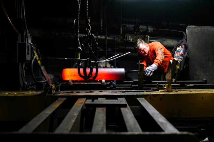 An employee of the Scranton Army Ammunition Plant checks the shape of a steel ammunition tube being made to send to Ukraine