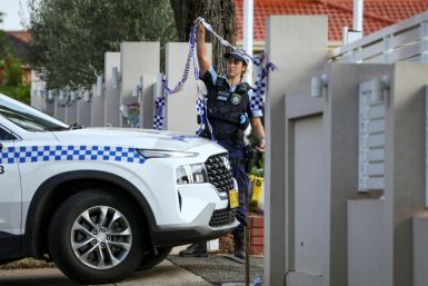 A police officer lifts tape to let a car into the Christ the Good Shepherd Church in western Sydney, scene of a live-streamed stabbing earlier in the week