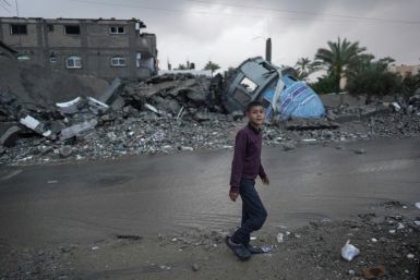 A Palestinian boy walks past a destroyed mosque in Deir el-Balah, which became a focus of the fighting in Gaza