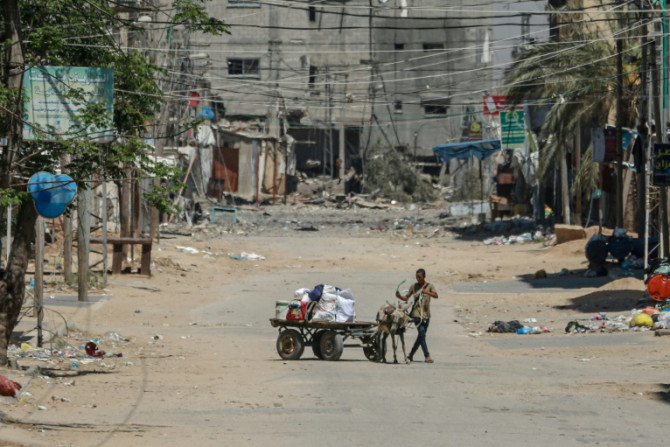 A man with his belongings loaded on a cart flees the city of Nuseirat in the central Gaza Strip on April 17, 2024