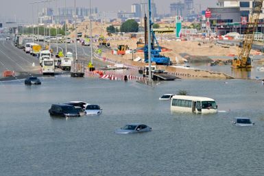 Vehicles lie abandoned in the floodwaters on a Dubai highway which was inundated by this week's downpours