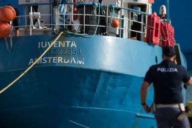 An Italian police officer stands by the Iuventa rescue ship run by German NGO Jugend Rettet (Youth Saves)