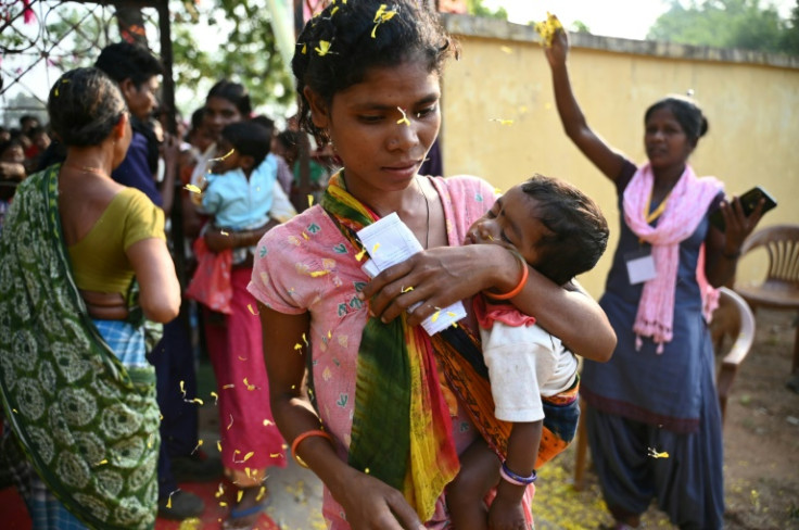 Voters were greeted with flowers as they arrived at a polling station India's Bastar district, where many were previously too fearful to vote because of Maoist guerillas