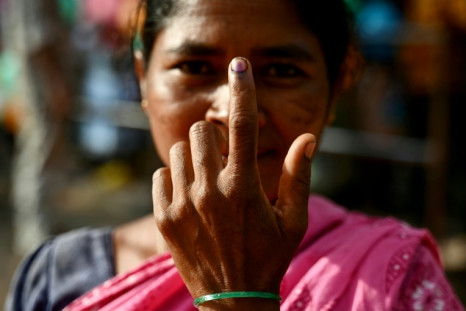 A woman shows her inked finger after voting in  Indian general elections in Dugeli in Chhattisgarh state, previous heartland of home to a decades-old Maoist insurgency