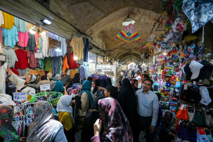 People shop at a bazaar in Iran's central city of Isfahan after a reported Israeli strike in the area