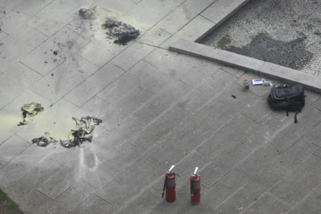 Fire extinguishers and a backpack are left at the park across from Manhattan Criminal Court after a man set himself on fire during the trial of Donald Trump