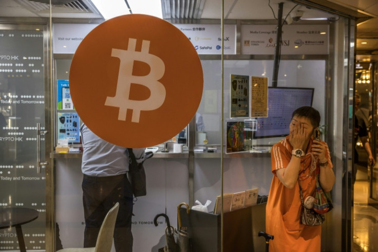 A woman uses her phone outside a cryptocurrency exchange in Hong Kong