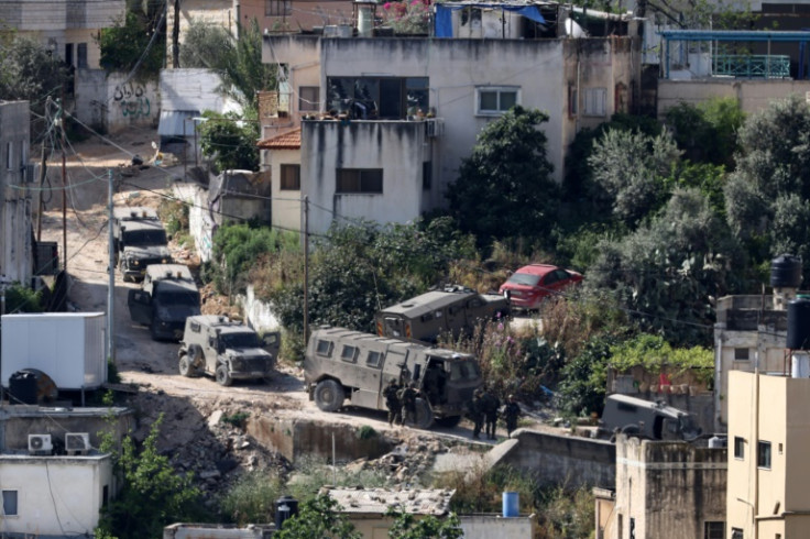 Israeli soldiers line up during a raid in the Nur Shams refugee camp in the occupied West Bank