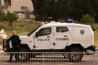 An Israeli policeman cordons off the Beit Einun junction area, after the latest deadly incident in the Israeli-occupied West Bank