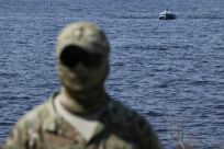 A Ukrainian soldier demonstrates a naval drone