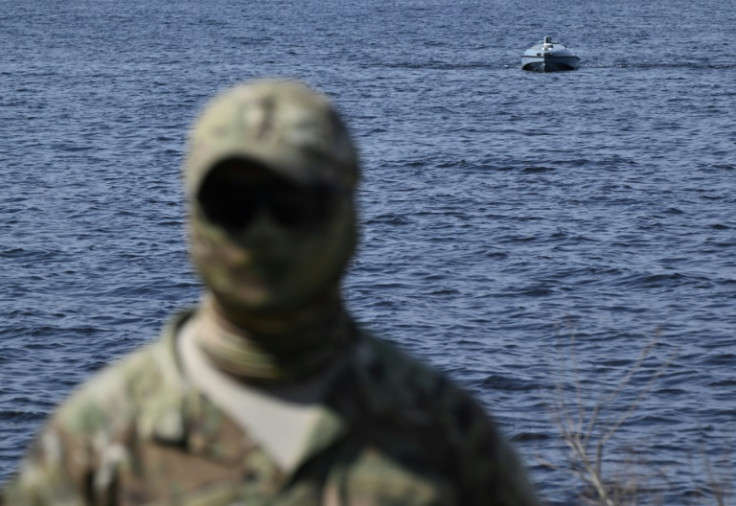 A Ukrainian soldier demonstrates a naval drone