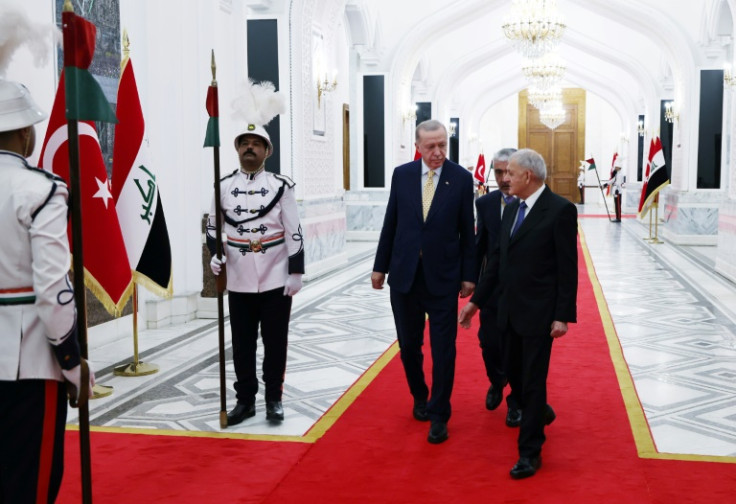 A photograph provided by the Turkish presidency press office shows Iraq's President Abdul Latif Rashid (R) welcoming Turkey's President Recep Tayyip Erdogan prior to their meeting at the Presidential palace in Baghdad