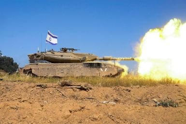 An Israeli army battle tank firing rounds while operating in the Gaza Strip