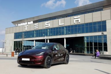 A Tesla car stands in front of the company's electric car plant in Gruenheide near Berlin, Germany, on March 13, 2024