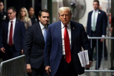 Former US President Donald Trump, with attorney Todd Blanche (L), walks toward the press to speak after attending his criminal trial for alleged business record fraud