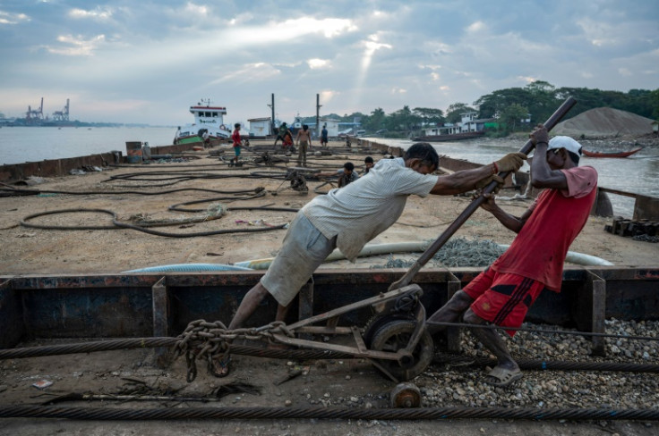 Workers attach cables to the sunken ships, then slowly tighten them after each tide raises the wreck, bringing it into shallower waters nearer the shore