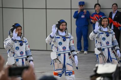 Astronauts for China's Shenzhou-18 space mission (L-R) Li Guangsu, Li Cong and Ye Guangfu wave during a departure ceremony