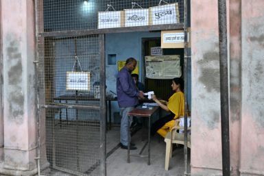 Officials prepare for voting in the second phase of India's general elections at a polling station in Vrindavan on Friday