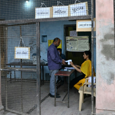 Officials prepare for voting in the second phase of India's general elections at a polling station in Vrindavan on Friday