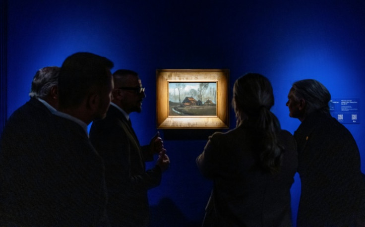 Visitors look at Van Gogh's "Country Huts Among Trees" at the Museum of John Paul II and Primate Wyszynski in Warsaw, Poland