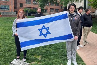 Philosophy student Skyler Sieradzky, 21, left, holds an Israeli flag as pro-Palestinian protesters stage a sit-in on the urban campus of George Washington University in Washington
