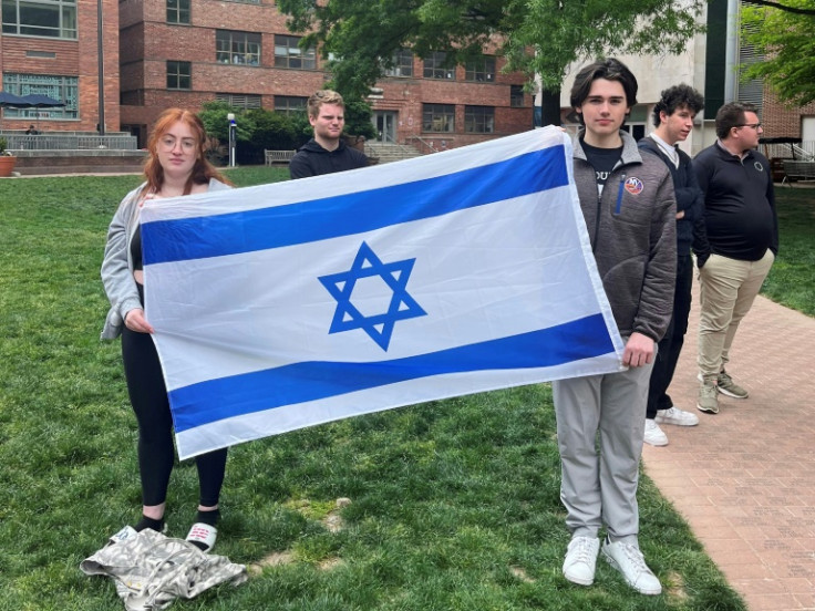 Philosophy student Skyler Sieradzky, 21, left, holds an Israeli flag as pro-Palestinian protesters stage a sit-in on the urban campus of George Washington University in Washington