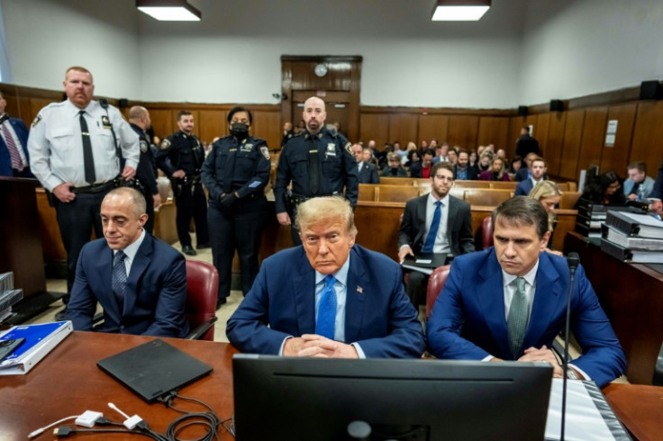 Former president Donald Trump in court with his attorney Todd Blanche (R) and Emil Bove (L)