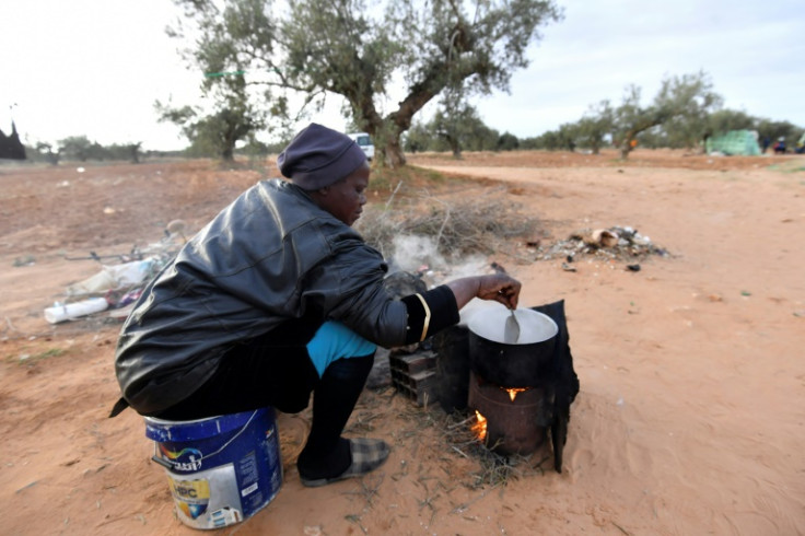 Cooking in the outdoors among the olive trees at a camp in El Amra