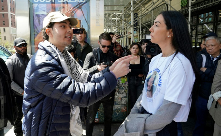 (L-R) A pro-Palestinian supporter and a supporter of Israel argue with each other on the sidewalk after a rally outside of Columbia University