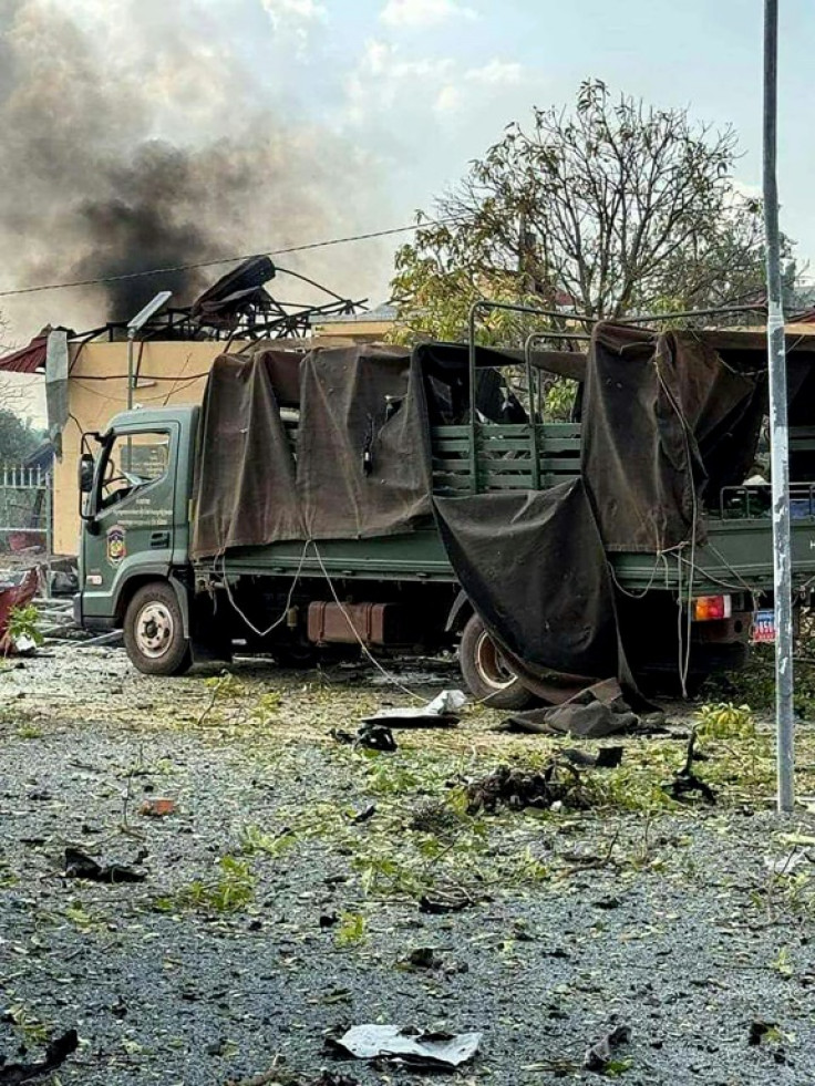 A damaged military truck following an explosion at an army base in Cambodia