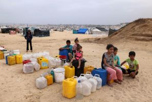 Displaced Palestinian children wait for water at their tent camp in Rafah -- the UN children's agency estimates the war has displaced around 850,000 children in Gaza