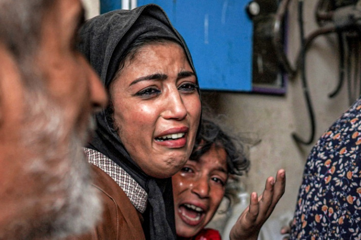 A woman and a girl cry after Israeli bombardment hits Nuseirat in the central Gaza Strip on April 29, 2024