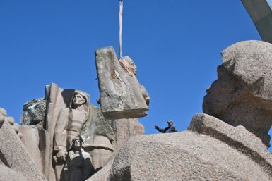 Workers dismantle the Soviet-era monument, which commemorates the signing in 1654 of a treaty binding Ukraine to Russian rule