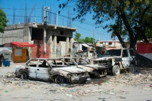 Vehicles charred from gang violence are seen in Port-au-Prince in March 2024