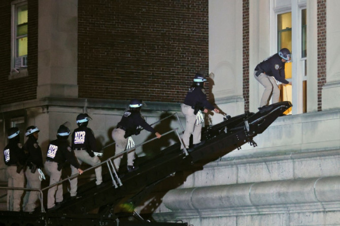 Tuesday evening, police climbed into the barricaded Hamilton Hall via a second-floor window, before leading people in handcuffs out of the building into vans