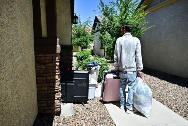 A man and his family gather their belongings after being evicted from a residential property