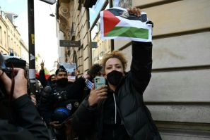 Some demonstrators held up Palestinian flags as they were led away