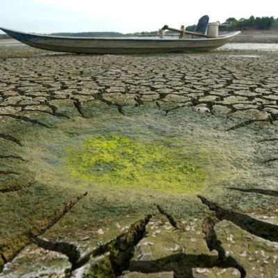 A boat sits on a dried-up reservoir bed in southern Vietnam's Dong Nai province last month