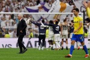 Winning coach: Real Madrid boss Carlo Ancelotti leaves the pitch as players celebrate their victory