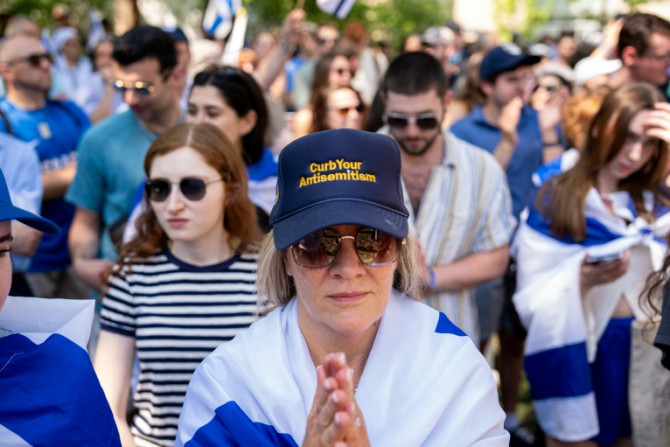 A woman wears a hat that reads "Curb Your Antisemitism" during a rally against campus antisemitism at George Washington University on May 2