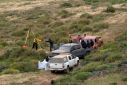 Rescuers are seen working at a clifftop shaft where bodies believed to be those of three missing surfers were discovered
