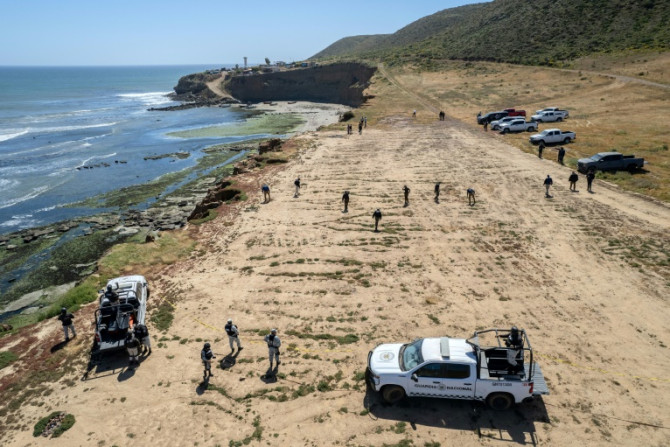 State prosecutors search the camping site of two Australians and an American murdered during a surfing trip to Mexico