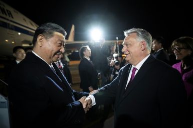 Chinese President Xi Jinping (L) is greeted by Hungarian Prime Minister Viktor Orban (R) at the airport