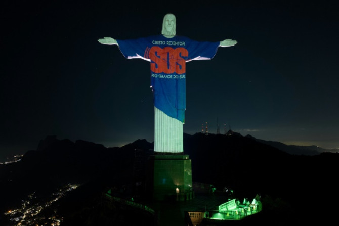 The Christ the Redeemer statue in Rio de Janeiro was lit up Wednesday night in homage to the victims, with a message appealing for more donations