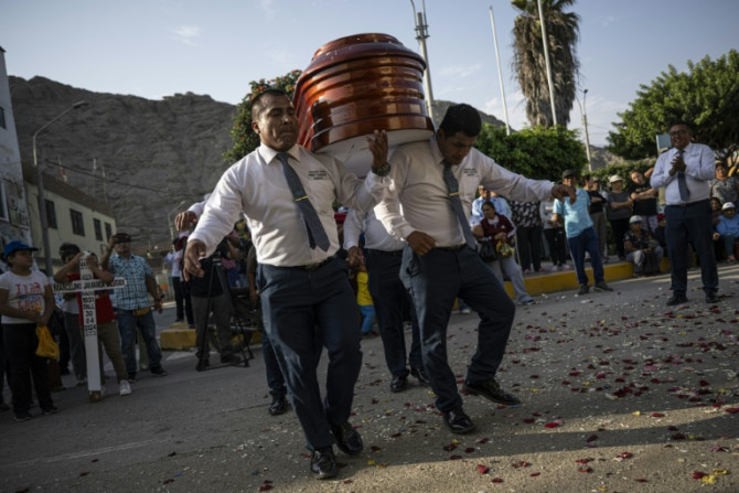 Peru's 'dancer's of death' show off intricate footwork as they bear a coffin to its final resting place