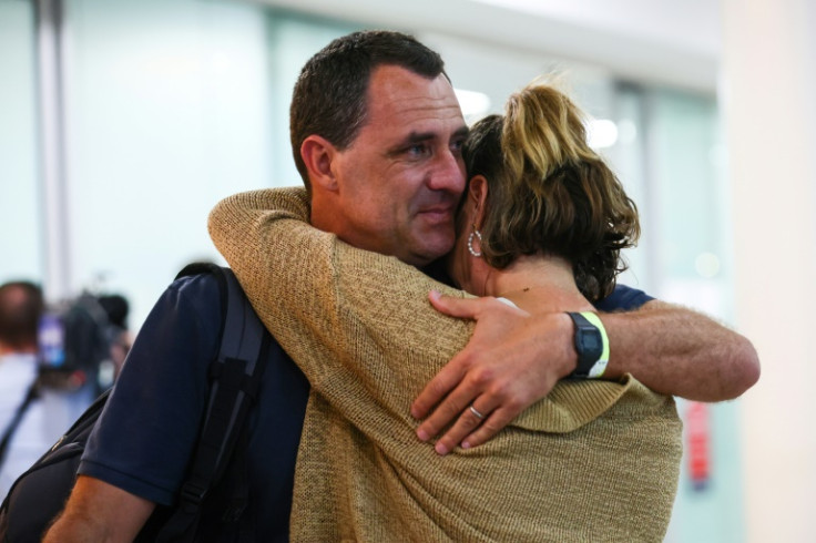 Chris Salmon embraces his wife Marney after arriving in Brisbane from New Caledonia on May 21, 2024