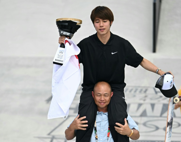 Japan's Yuto Horigome is hoisted on to the shoulders of coach Daisuke Hayakawa after qualifying for the Olympics at an event in Hungary last month
